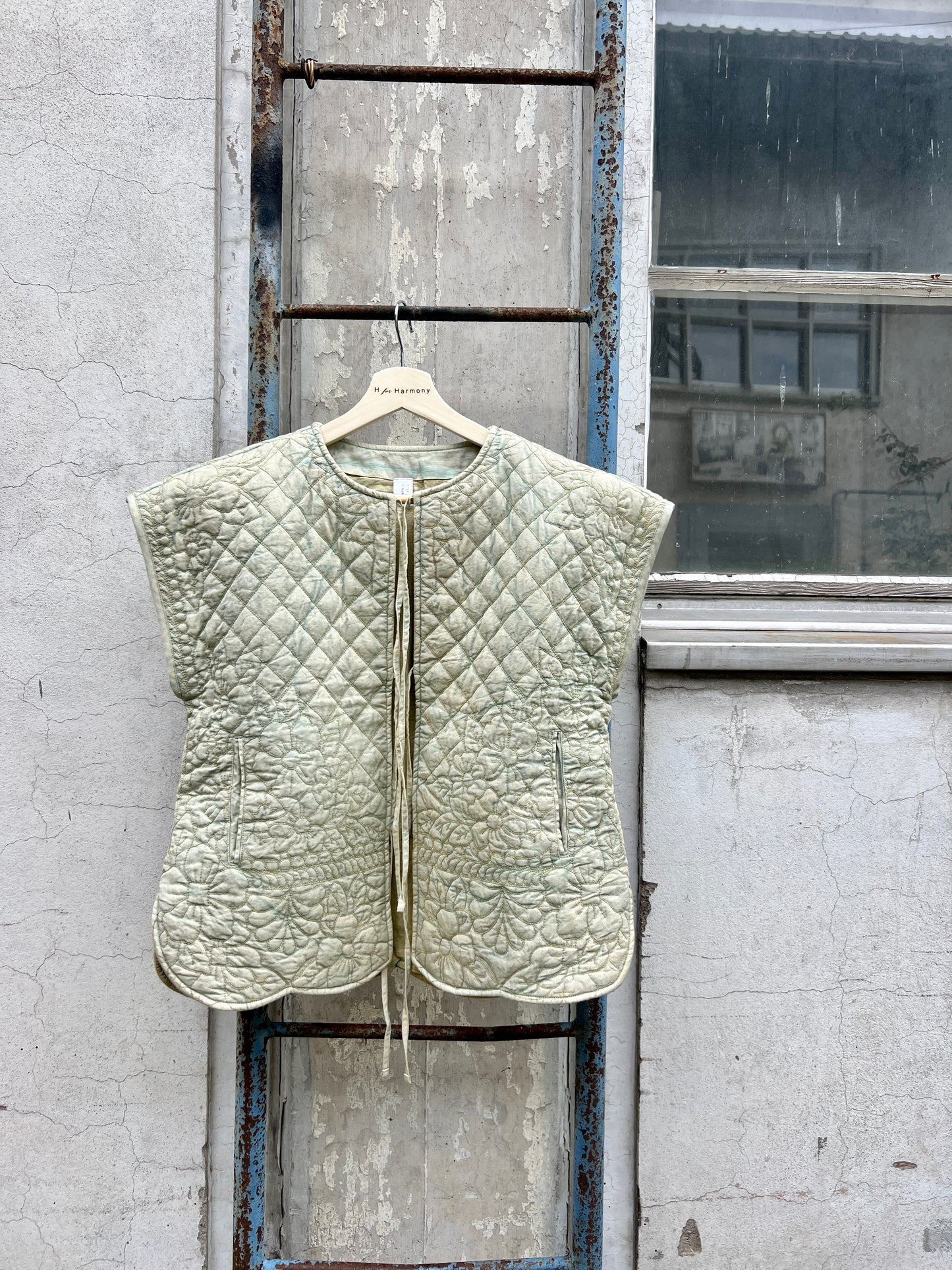 Quilted vest hanging on a door in an urban setting