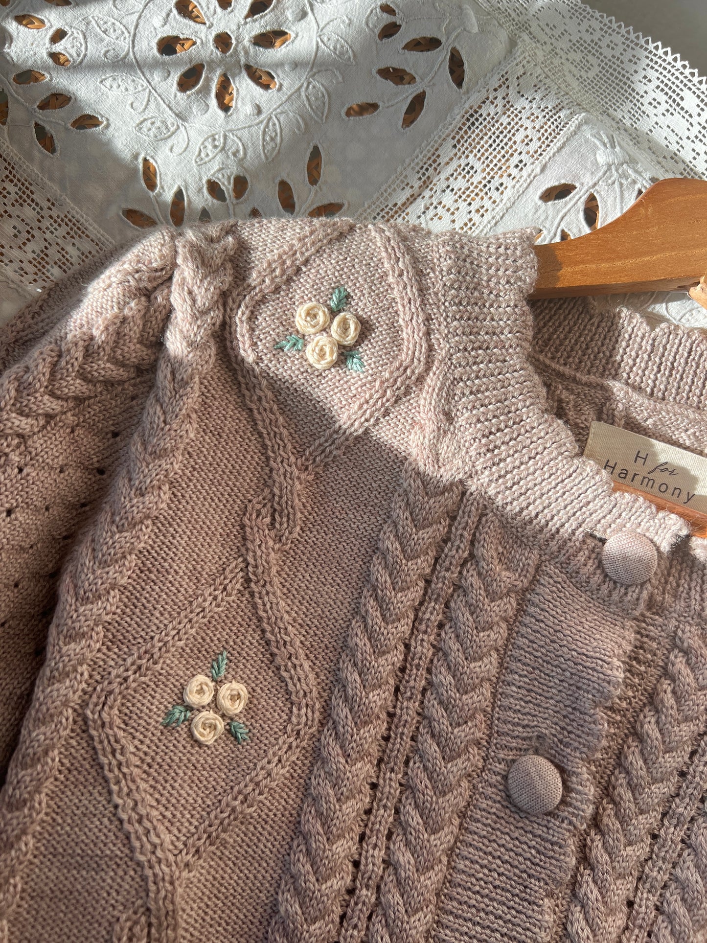 Sienna Cardigan in organic merino wool with delicate cable knit and embroidered flowers, showcasing romantic vintage style.