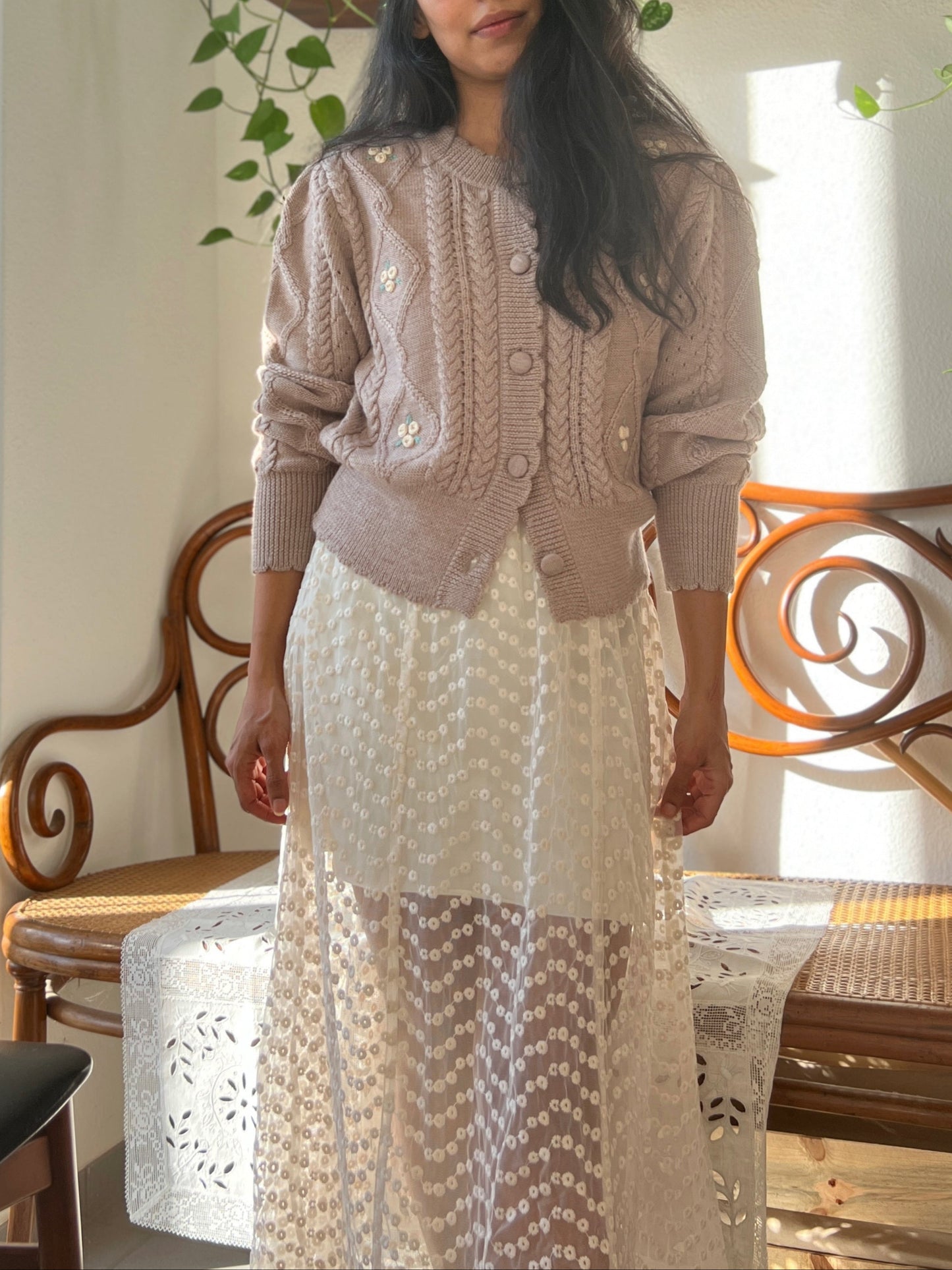 Sienna Cardigan in organic merino wool with puff sleeves and embroidered flowers, styled with a sheer dotted skirt.