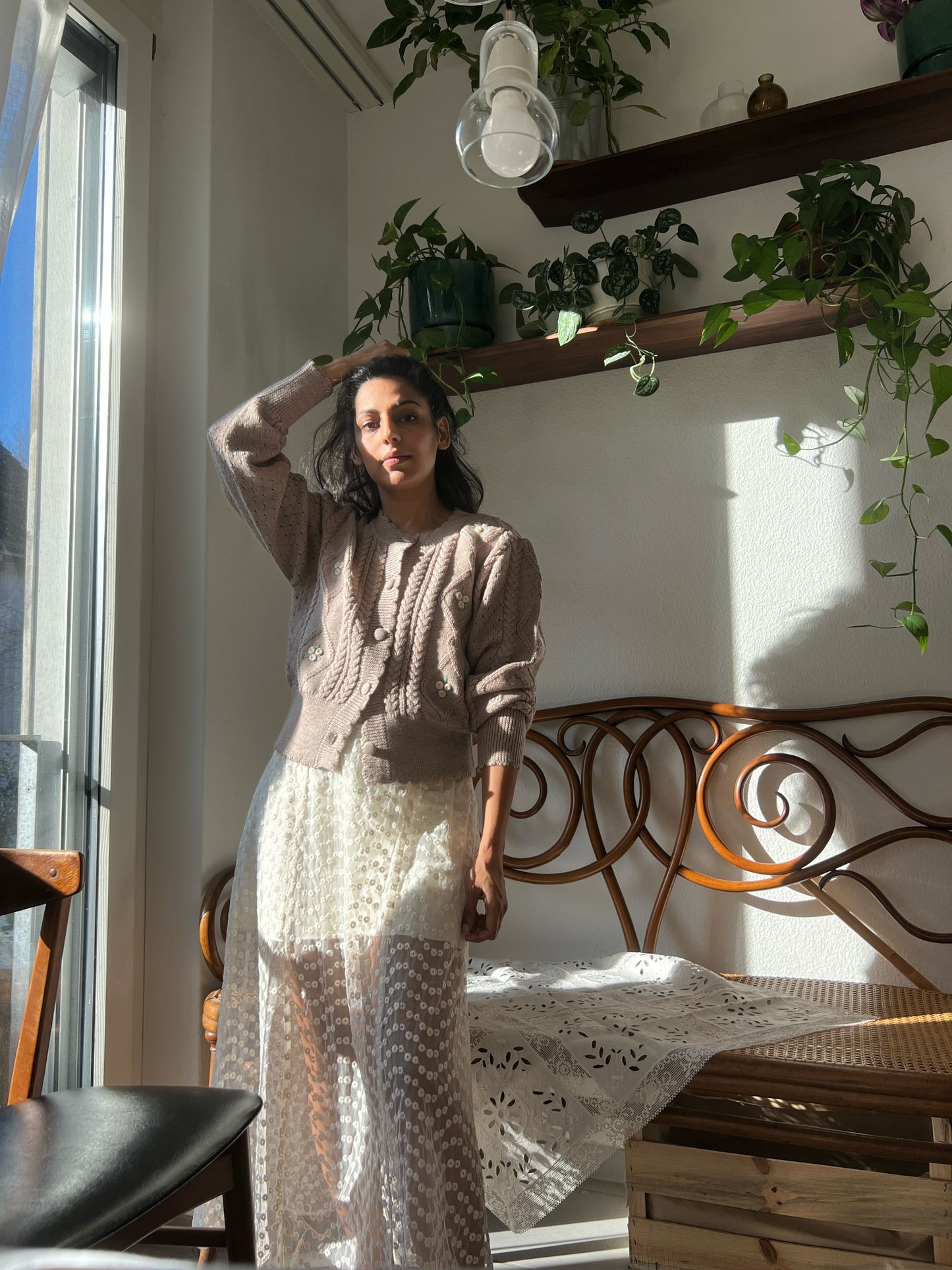 Woman wearing a Sienna Cardigan in organic merino wool styled with a cream skirt.