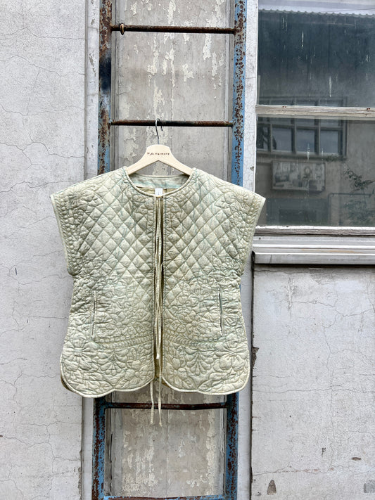 Quilted vest hanging on a door in an urban setting